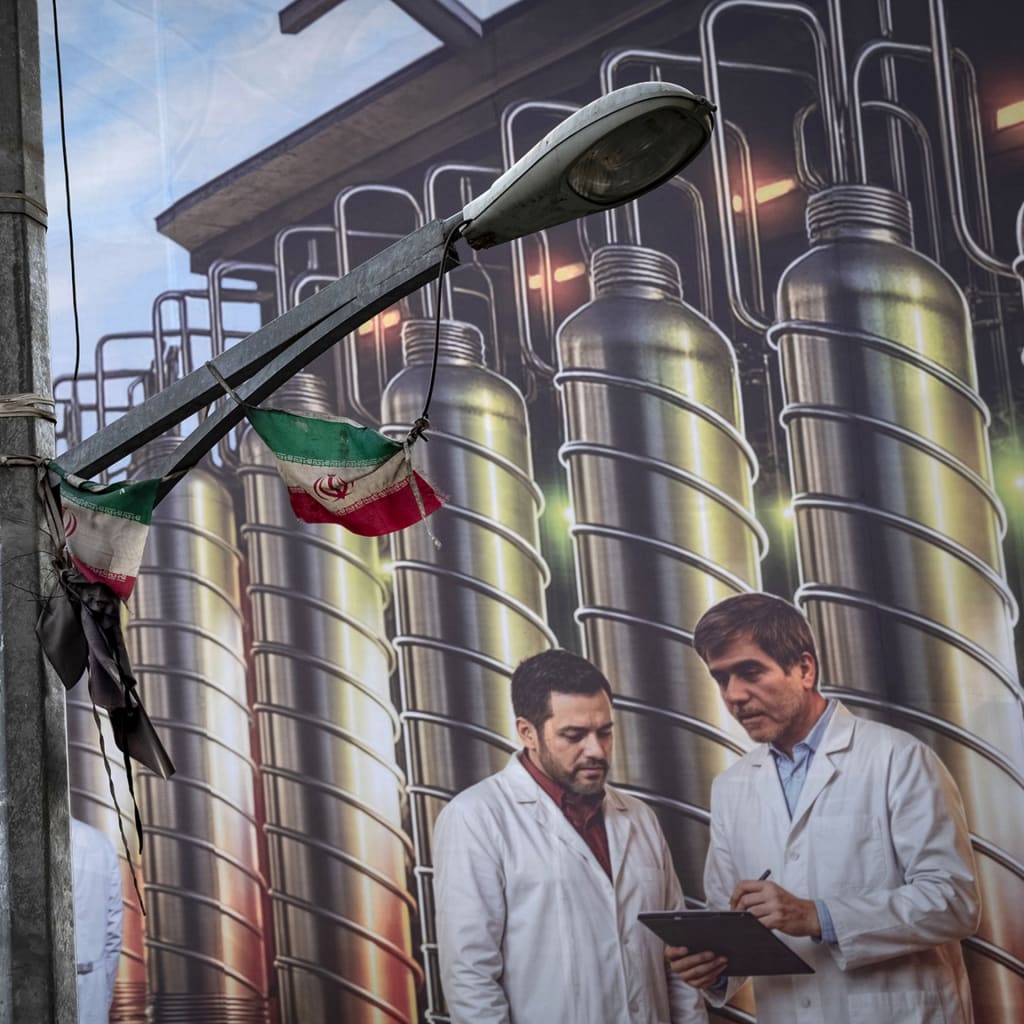 A giant banner featuring symbolic images of the Natanz nuclear enrichment facility, Iranian nuclear scientists killed in Israeli attacks during the 12-day war, and a Persian script that reads, ''Science is power,'' hangs from a governmental building in downtown Tehran, Iran, on August 28, 2025.