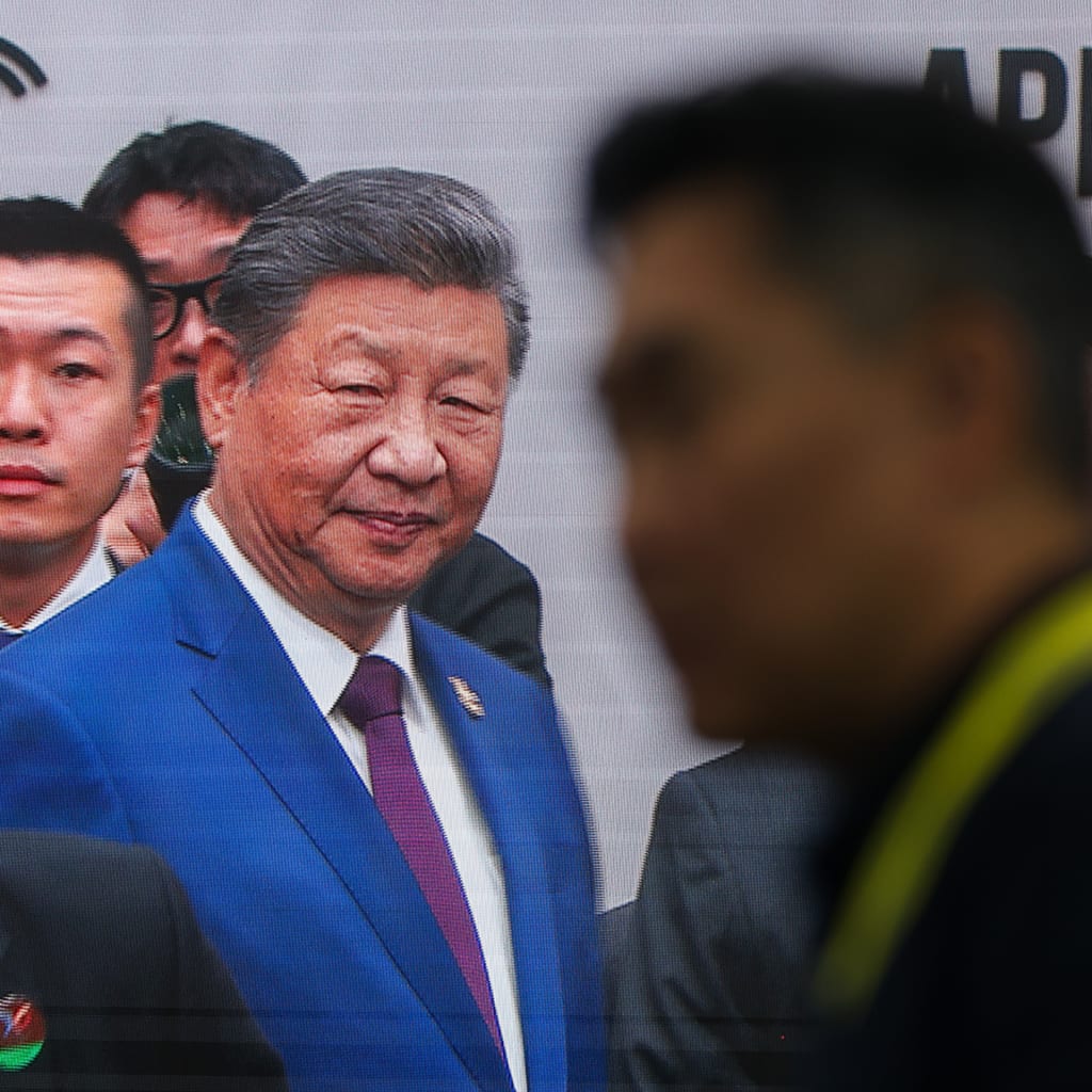 Chinese President Xi Jinping is seen greeting world leaders on a broadcast screen, as they meet during the APEC Economic Leaders' Week, in Gyeongju, South Korea, on November 1, 2025.