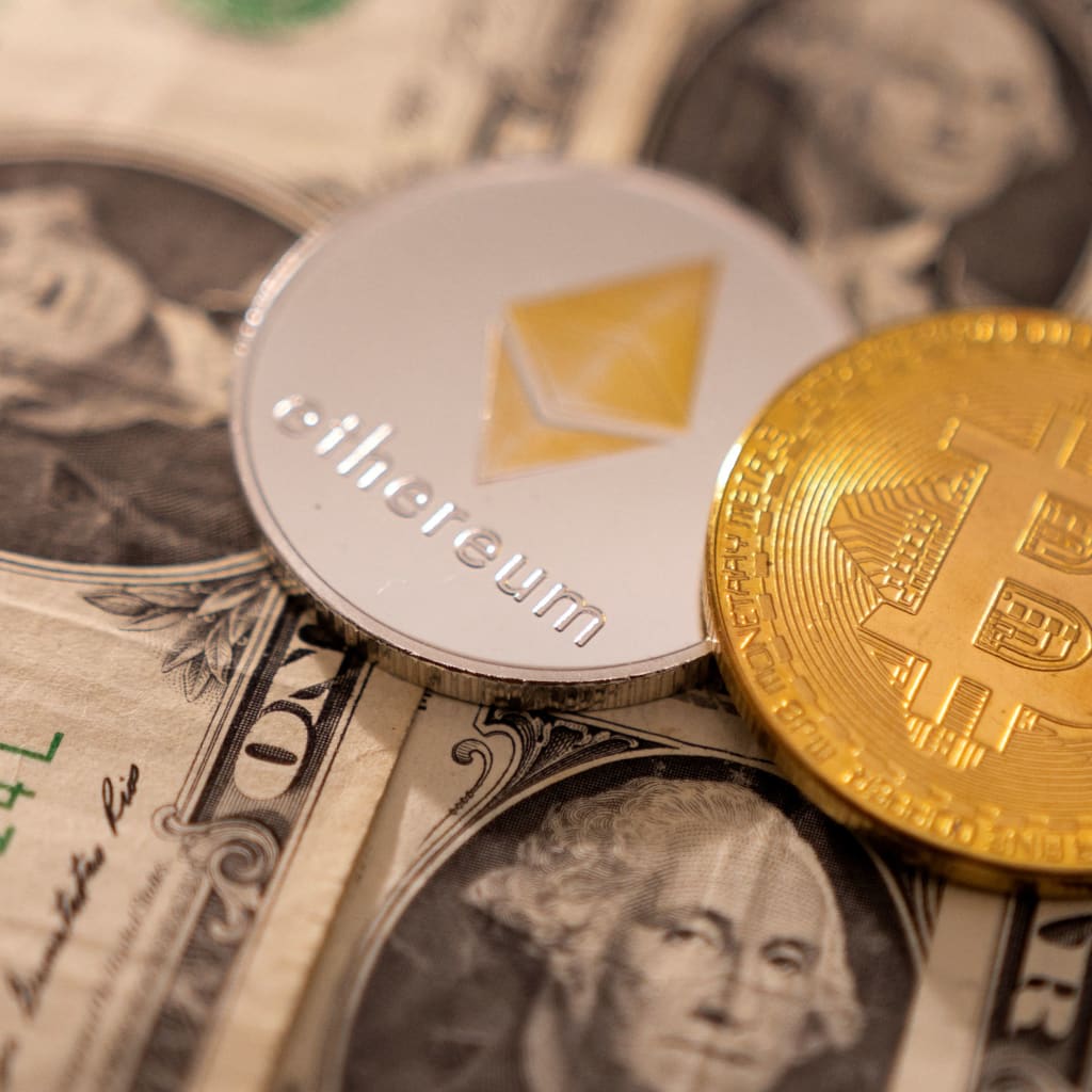 A representations of cryptocurrency Bitcoin and Ethereum placed on U.S. dollars
