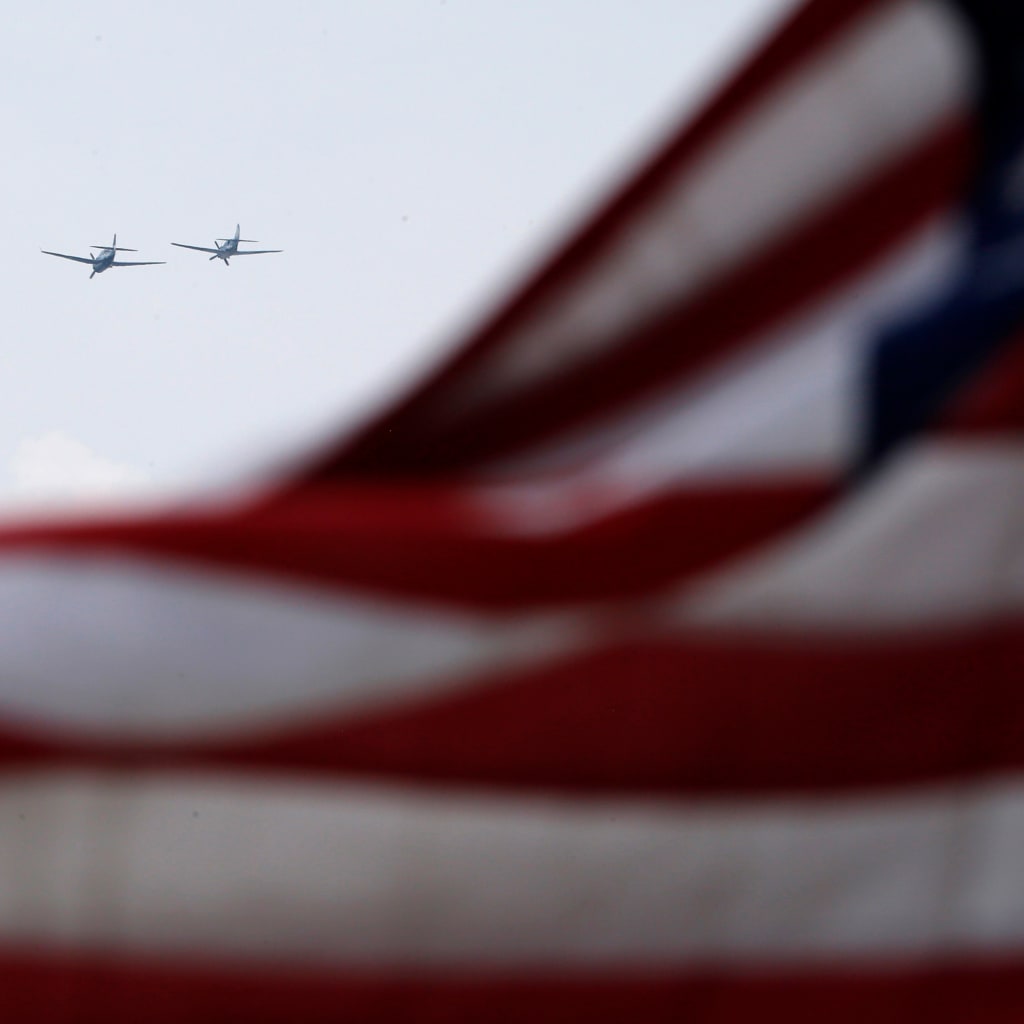 World War II era planes fly over U.S. flag during ceremony to commemorate the 70th anniversary of VE Day in Washington.