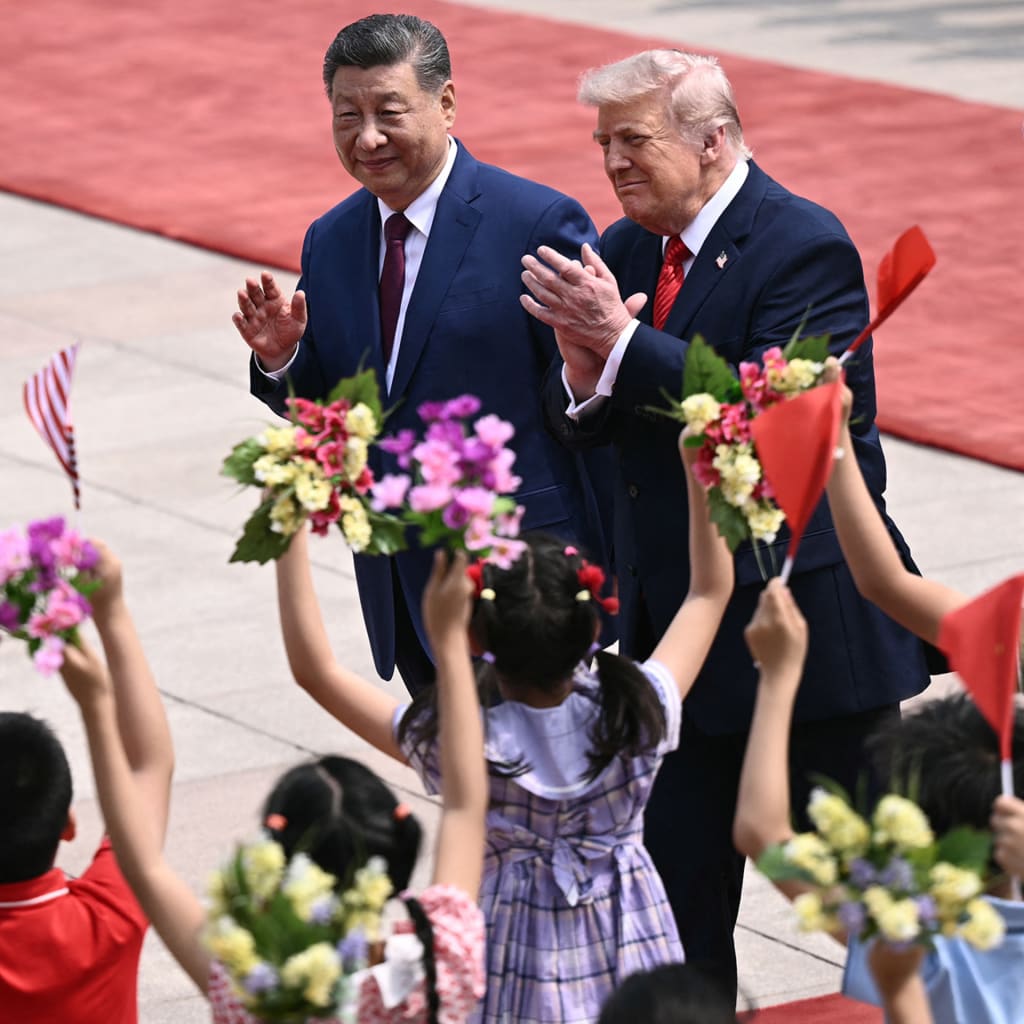 <p>US President Donald Trump (R) and China’s President Xi Jinping (L) during a welcome ceremony at the Great Hall of the People in Beijing on May 14, 2026. </p>
