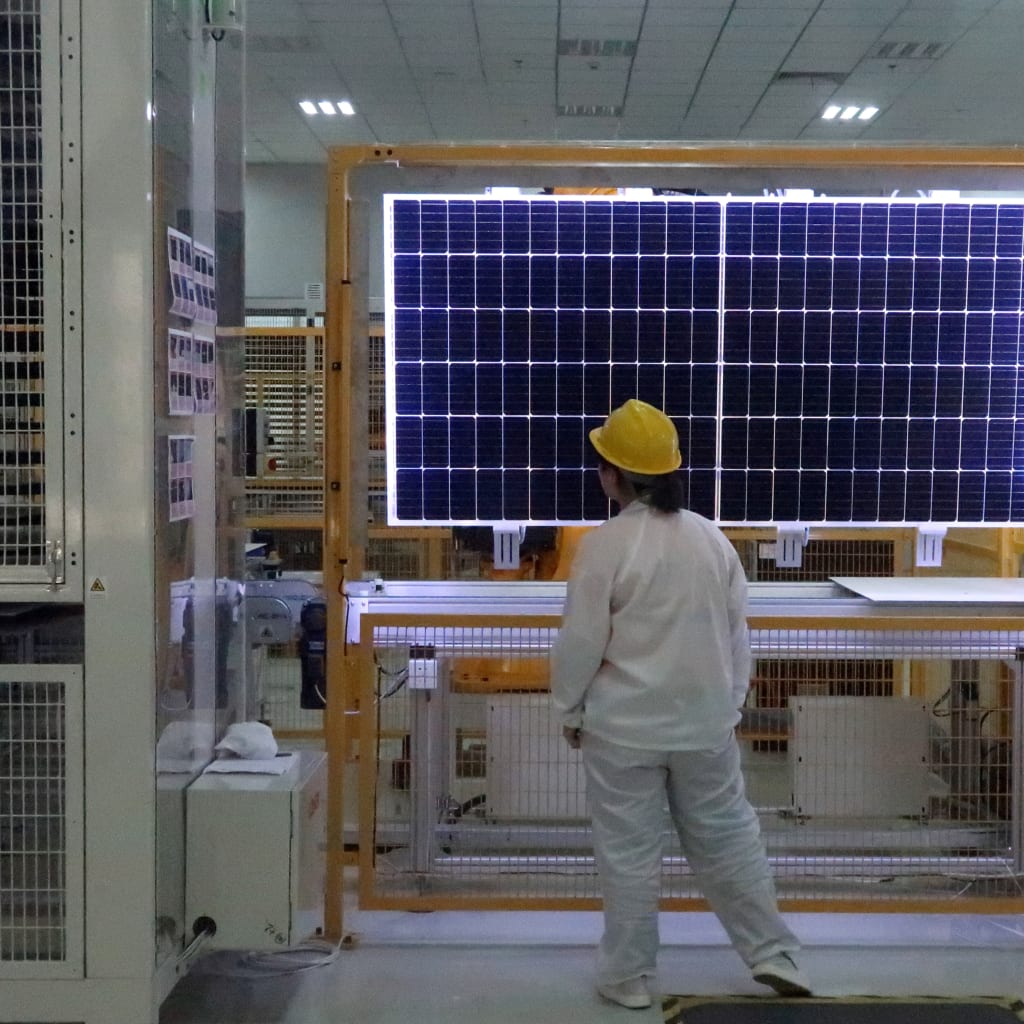 A worker conducts quality-check of a solar module product at a factory of a monocrystalline silicon solar equipment manufacturer LONGi Green Technology Co, in Xian, Shaanxi province, China December 10, 2019. Picture taken December 10, 2019. REUTERS/Muyu Xu
