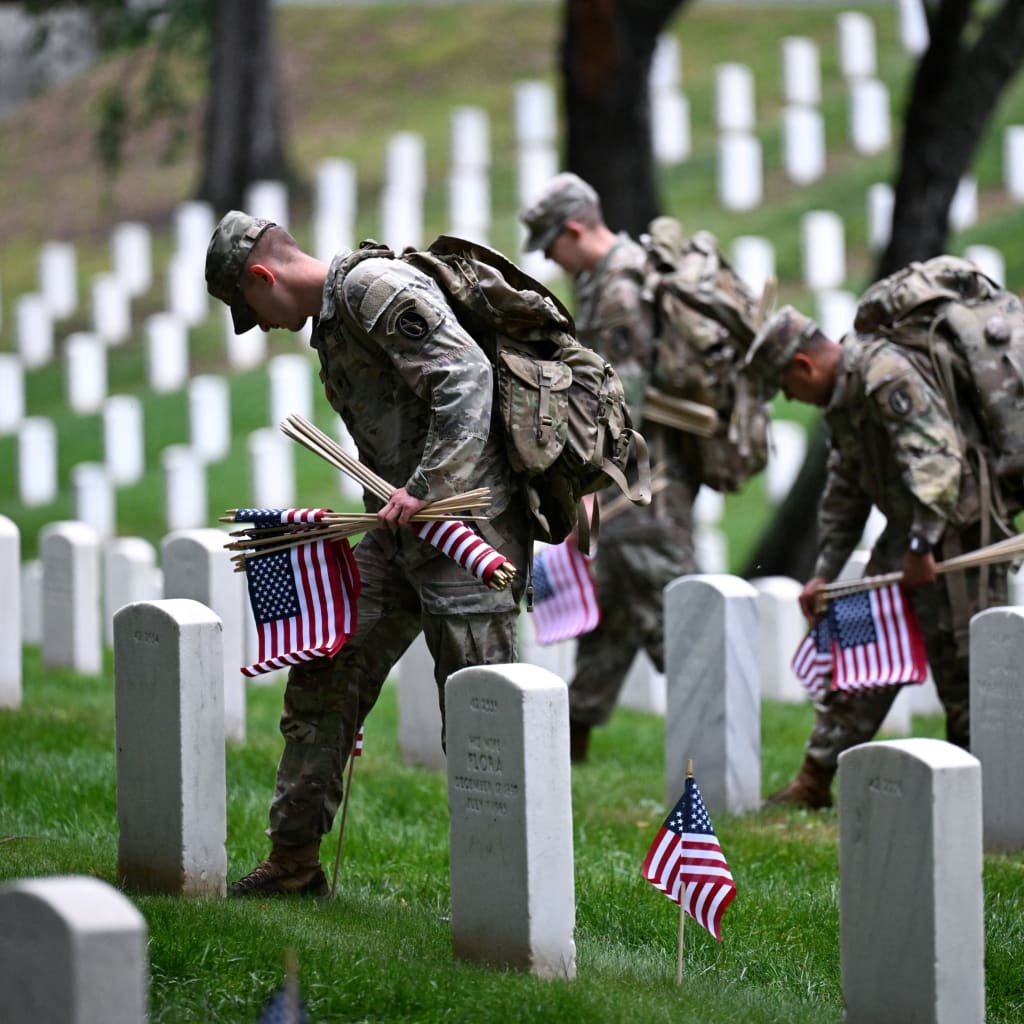 <p>Soldiers from the U.S. Army 3d Infantry Regiment, known as The Old Guard, place flags at service members’ graves in Arlington National Cemetery, May 21, 2026.</p>