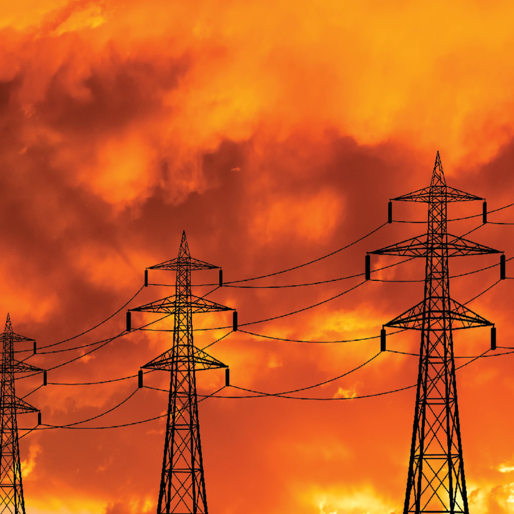 High voltage towers at sunset background. Power lines against the sky