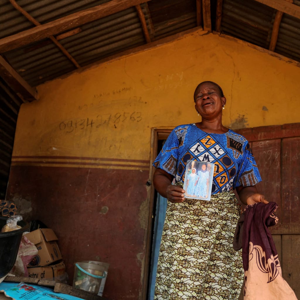 <p>Aduke Balogun, whose daughter was among dozens of pupils and teachers abducted in a large-scale school attack in southwestern Nigeria, reacts while displaying her daughter’s photograph and clothing after an interview with Reuters at her home in Yawota, Oyo state, Nigeria, on June 2, 2026.</p>
