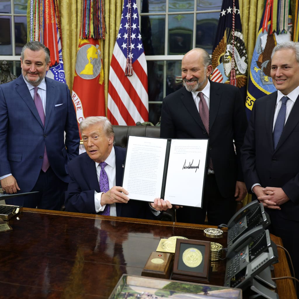 U.S. President Donald Trump displays a signed executive order as (2nd L-R) U.S. Sen. Ted Cruz (R-TX), Commerce Secretary Howard Lutnick and White House artificial intelligence (AI) and crypto czar David Sacks look on in the Oval Office of the White House on December 11, 2025 in Washington, DC.