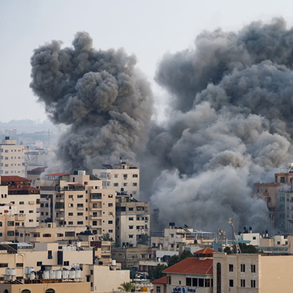 Smoke rises from buildings in Gaza following Israeli strikes.