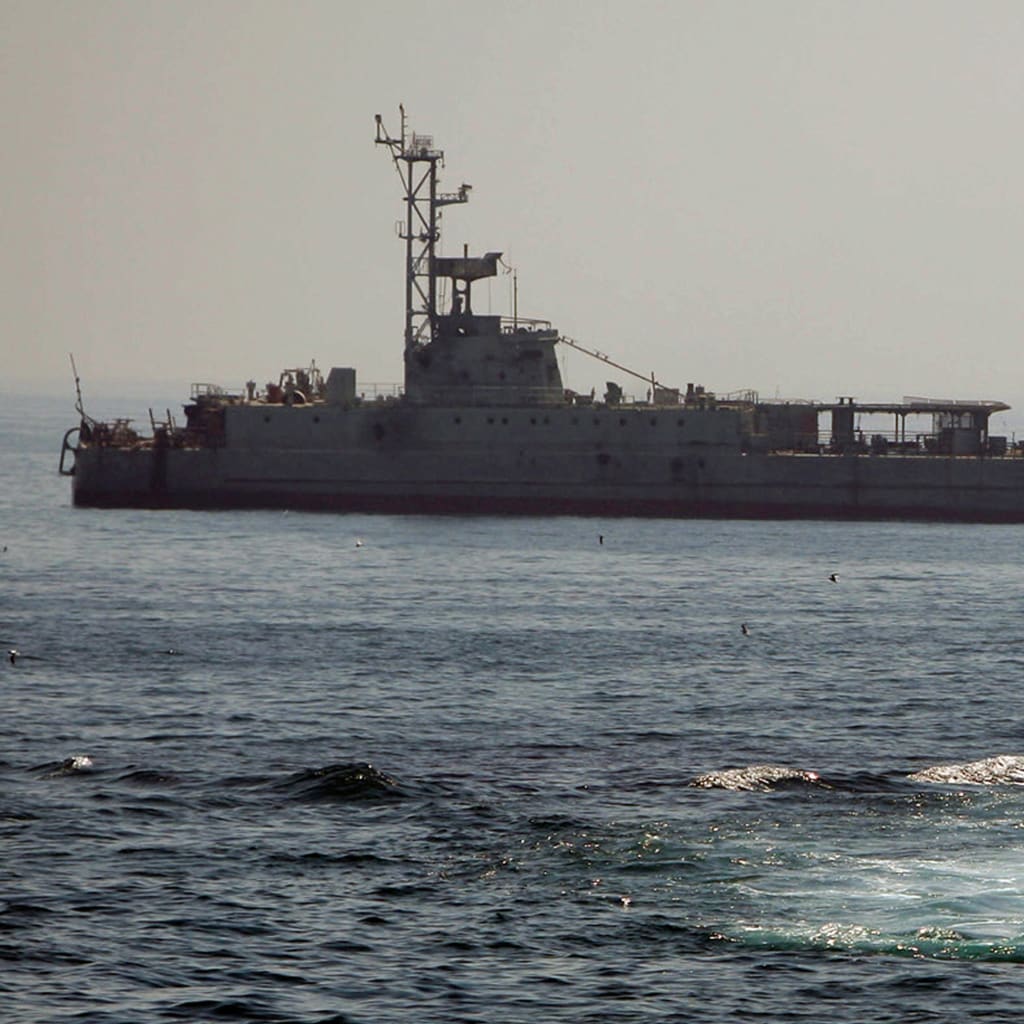 An Iranian warship and speed boats take part in a naval war game in the Persian Gulf and the Strait of Hormuz, southern Iran.