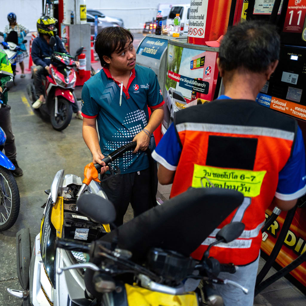 Riders with vehicles queue to fill up fuel at a gas station amid the U.S.-Israeli conflict with Iran, in Bangkok, Thailand, March 26, 2026.