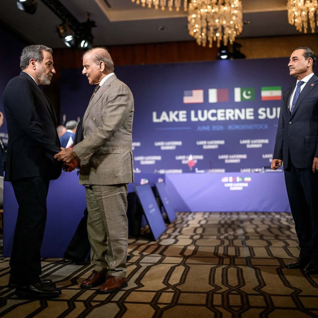 Iran's Foreign Minister Abbas Araqchi shakes hands with Pakistan's Prime Minister Shehbaz Sharif next to Pakistan's Chief of Army Staff Field Marshal Asim Munir prior to a quadrilateral meeting between the United States, Iran, Pakistan and Qatar at the Burgenstock luxury hotel complex overlooking Lake Lucerne, Switzerland, on June 21, 2026.