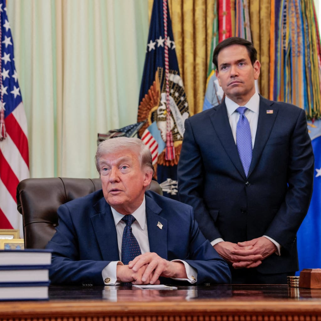 U.S. President Donald Trump speaks in the Oval Office, with Vice President JD Vance and Secretary of State Marco Rubio standing behind him, at the White House in Washington, D.C., U.S., on April 23, 2026.