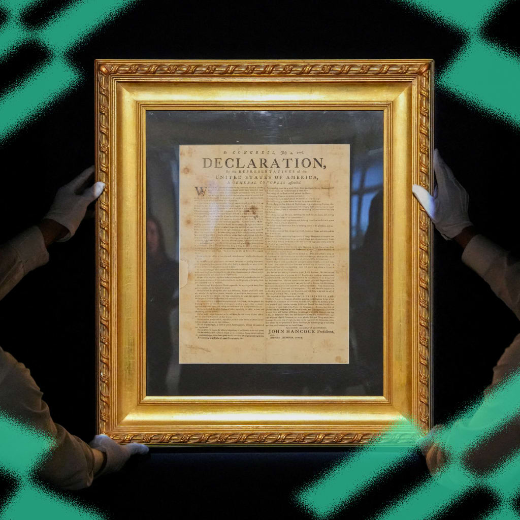 Handlers hold a July 1776 printing of the Declaration of Independence during a press preview at Sotheby's in New York City on January 17, 2025.