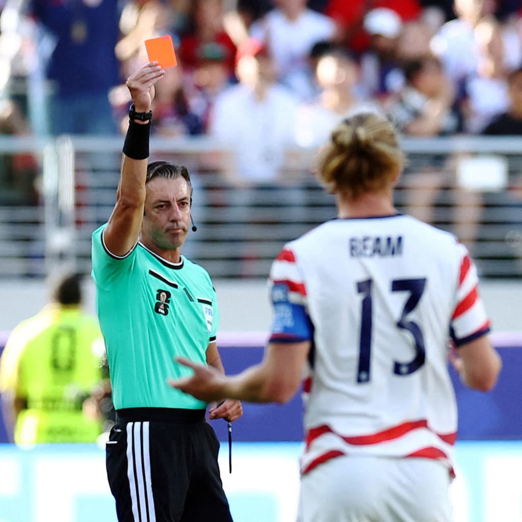 Folarin Balogun of the U.S. Men's National Team is shown a red card by referee Raphael Claus during a FIFA World Cup match against Bosnia and Herzegovina in San Francisco Bay Area Stadium, Santa Clara, California.
