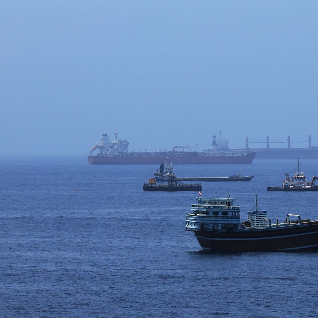 A view of commercial cargo vessels and crude oil tankers are anchored in the Gulf of Oman, off the coast of Muscat, Oman, on June 21, 2026, as they prepare to transit through the critical Strait of Hormuz.