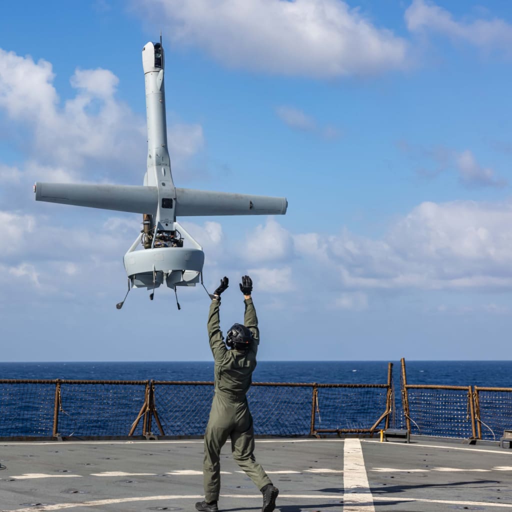 A U.S. Marine launches a VBAT on the deck of the USS Carter Hall.