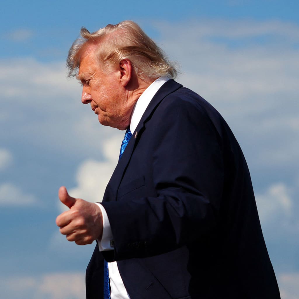 US President Donald Trump flashes a thumbs up while stepping off Air Force One upon arrival at Morristown Municipal Airport in Morristown, New Jersey, on July 31, 2026.