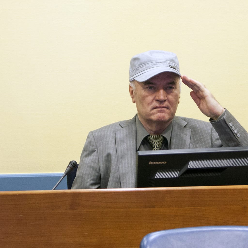 Ratko Mladić salutes as he makes his first appearance at the The International Criminal Tribunal for the former Yugoslavia.