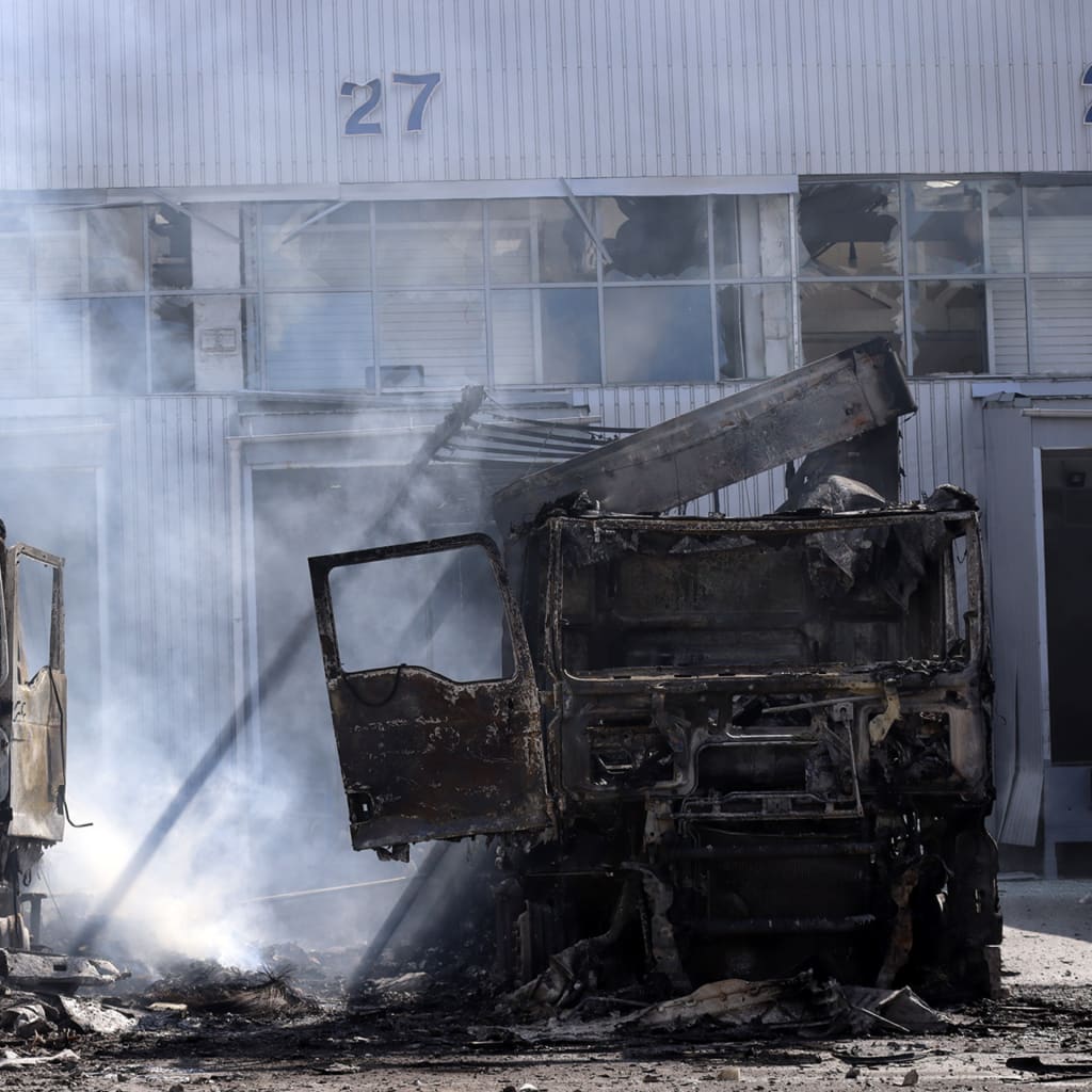 Burned-out trucks stand near a food warehouse hit by Russian drones on September 2, 2026, in Kyiv, Ukraine.