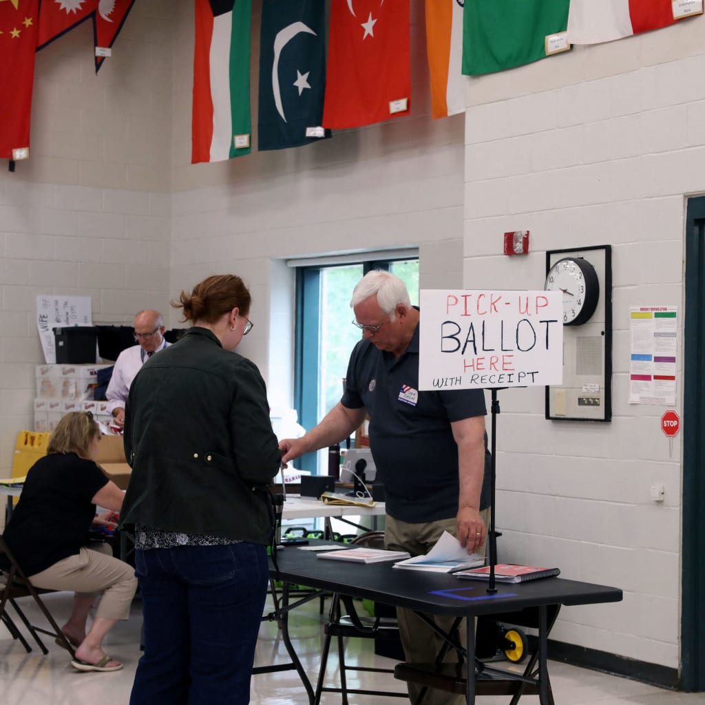 A voter collects her ballot at a polling station during the New Hampshire State Primary Election in Nashua, New Hampshire, U.S., September 8, 2026.