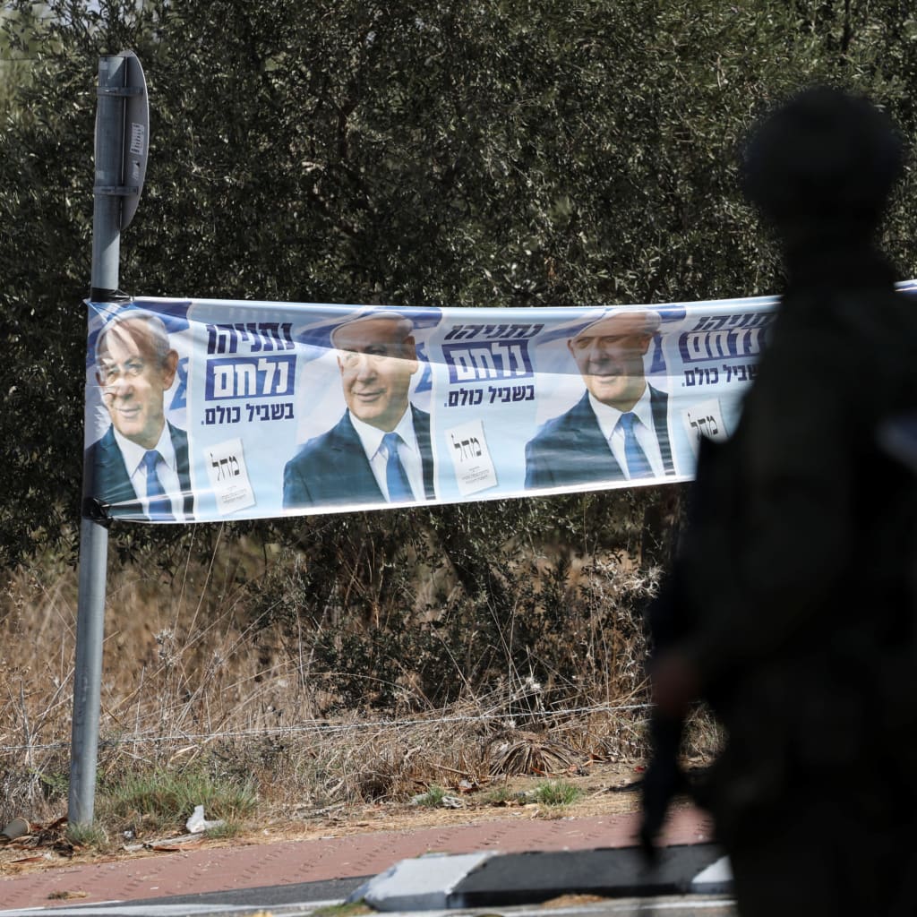 An election banner featuring Israeli Prime Minister Benjamin Netanyahu is displayed near Palestinian-owned olive groves in the village of Rantes near Ramallah, in the Israeli-occupied West Bank, October 6, 2026.