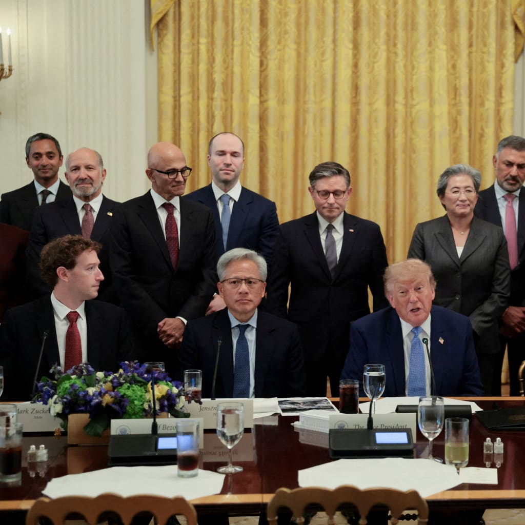Technology executives and U.S. officials gather around a long table in the White House East Room.