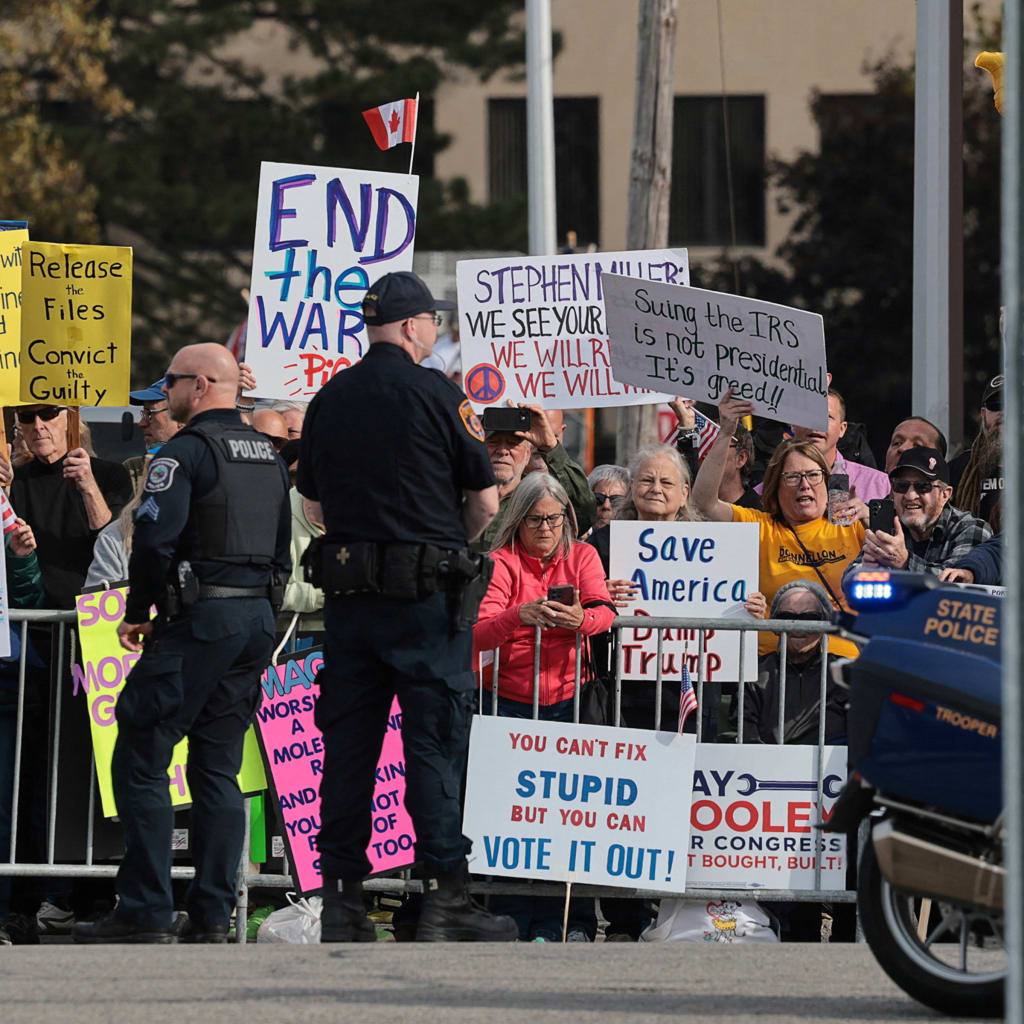 <p>Protesters demonstrate as President Donald Trump’s motorcade travels to an entertainment complex in Port Huron, Michigan, October 25, 2026.</p>
