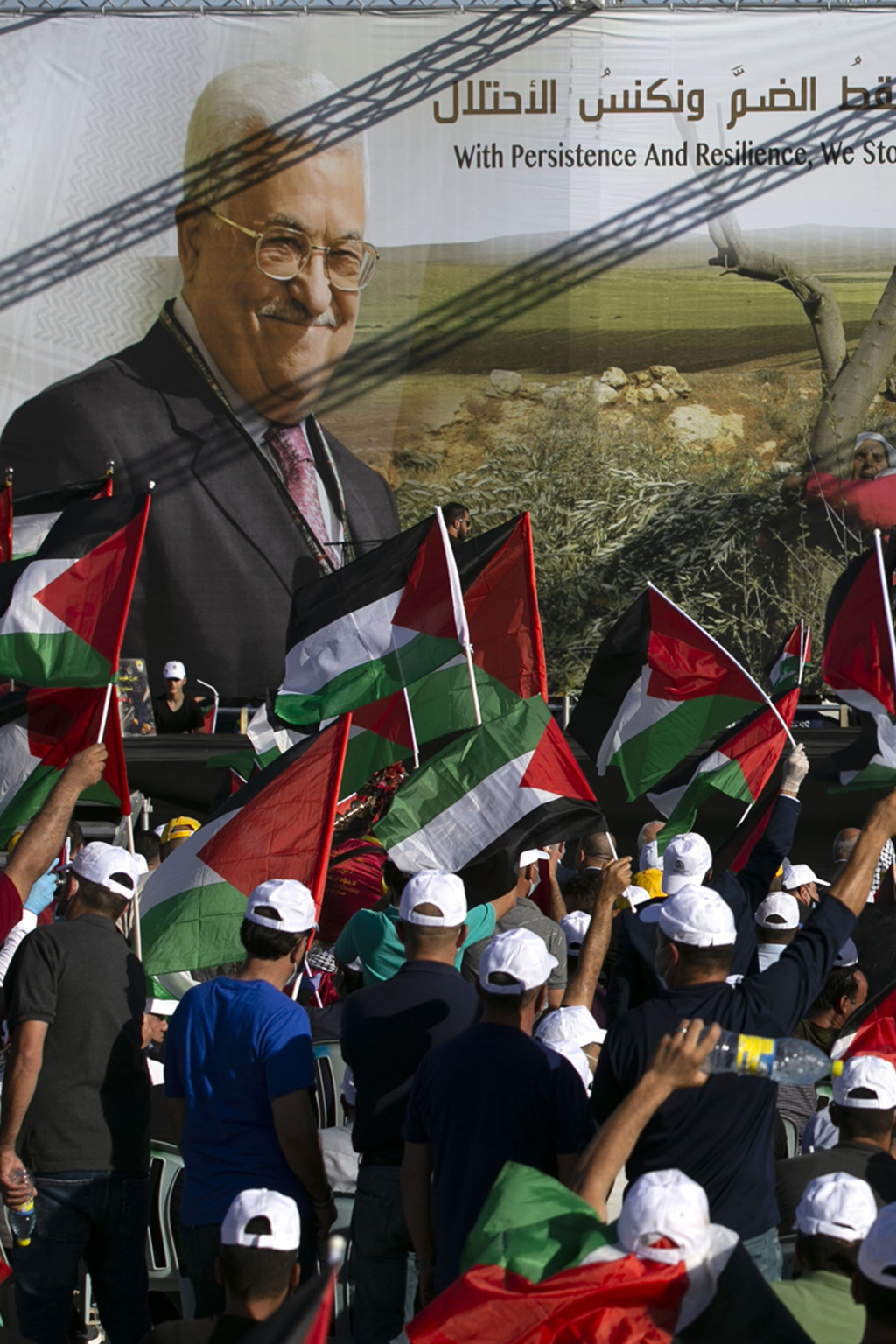 <p>Palestinians rally beneath images of President Mahmoud Abbas and his predecessor, Yasser Arafat.</p>
