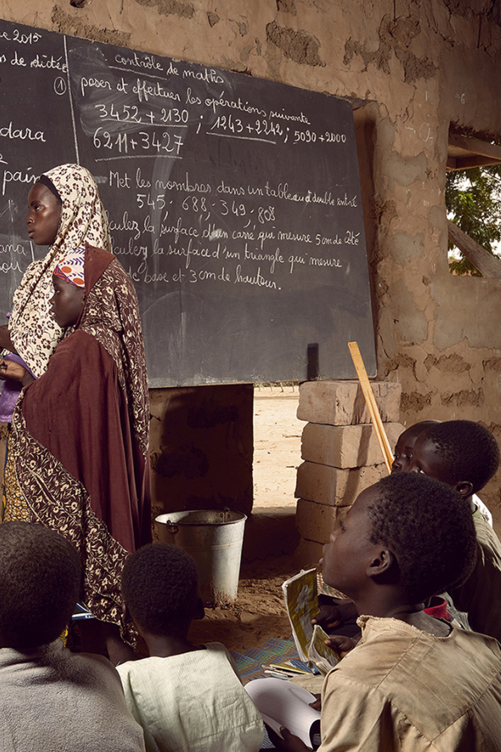 <p>Students use a converted prayer space as a classroom in Niger.</p>
