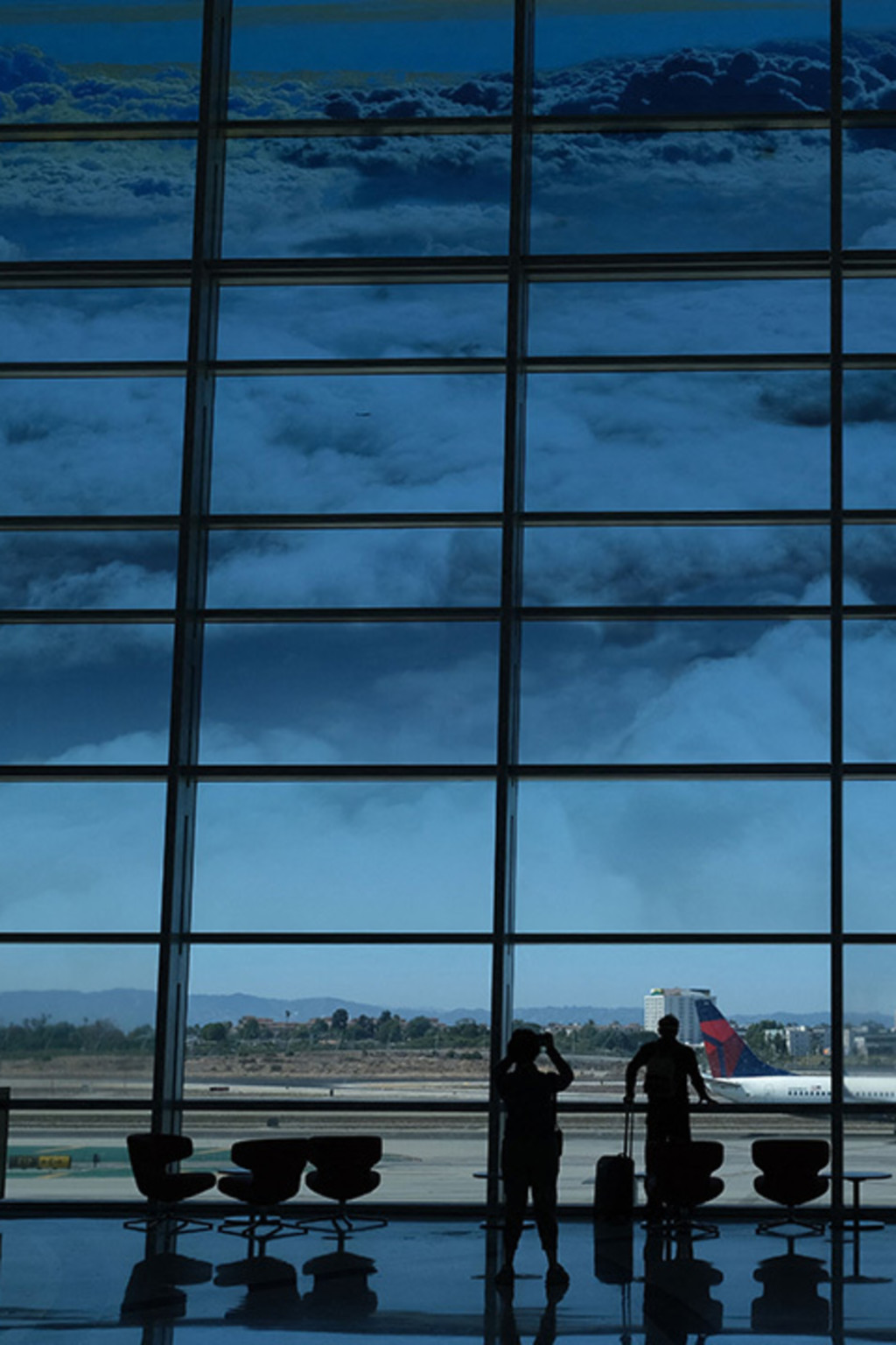 <p>Passengers gaze out the windows at Los Angeles International Airport.</p>
