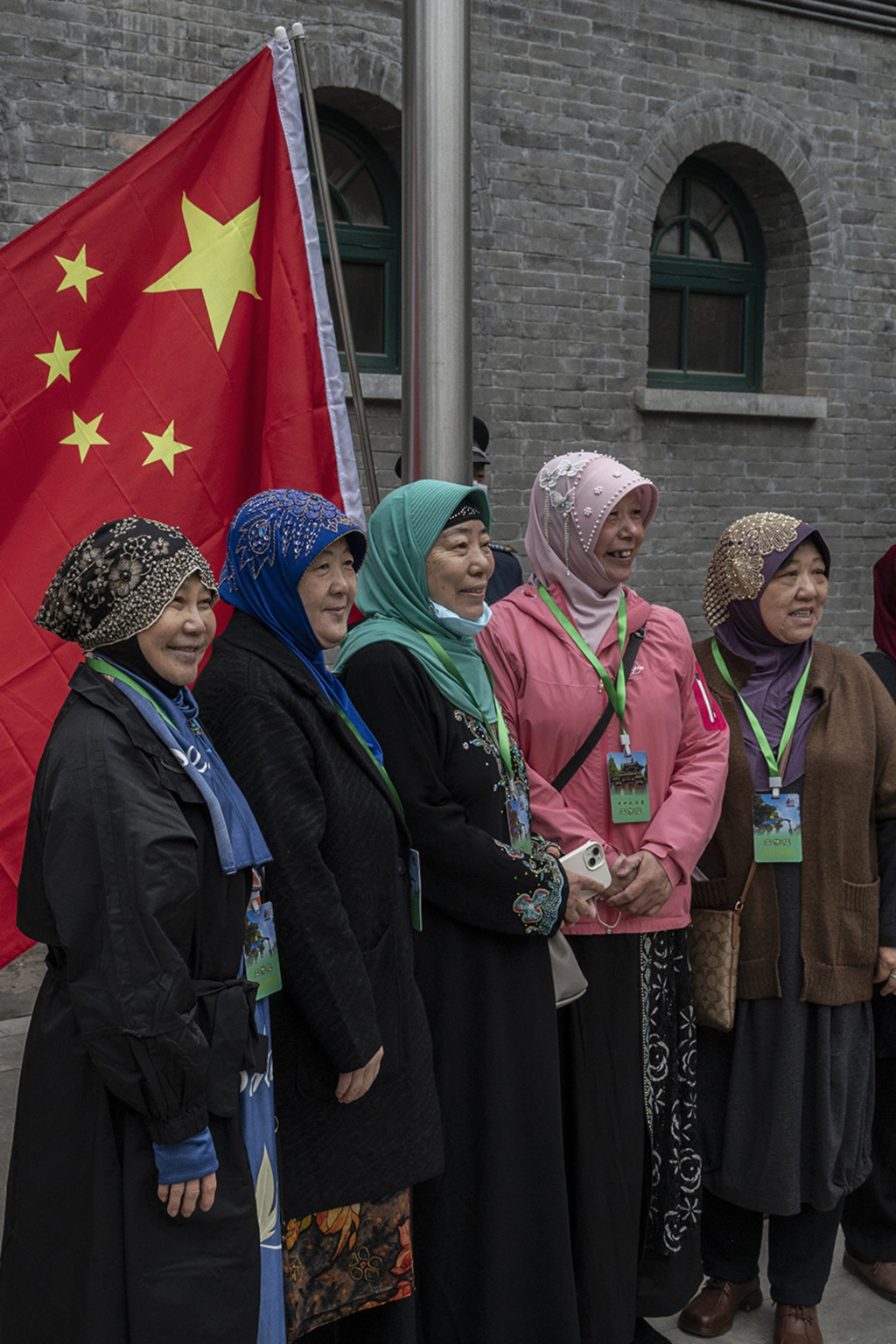 <p>Hui Muslim women stand in front of China’s flag at a mosque in Beijing.</p>
