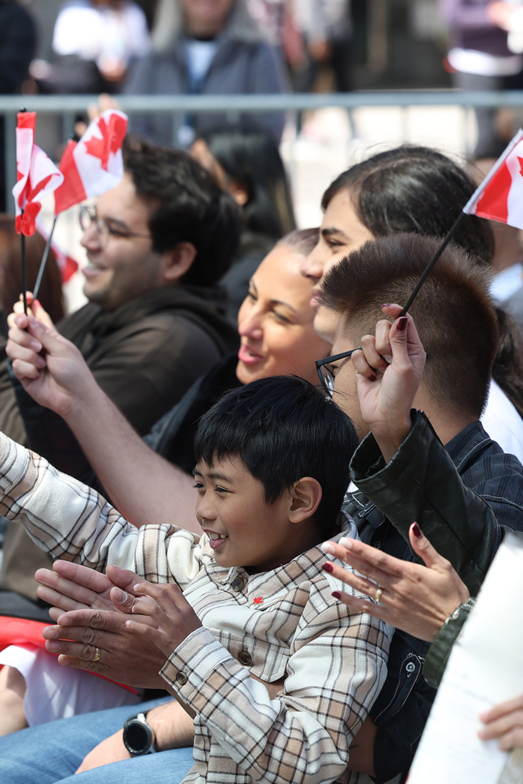 <p>New Canadians wave the national flag during a citizenship ceremony in Toronto.</p>
