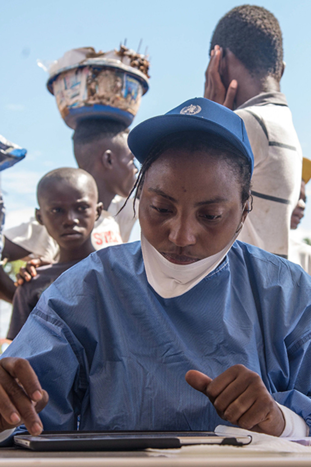 <p>A nurse working with the WHO prepares Ebola vaccines in the Democratic Republic of Congo.</p>
