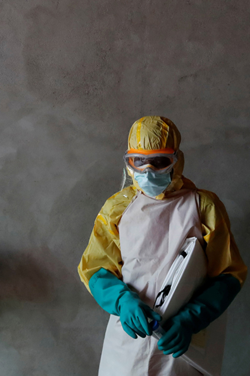 <p>A health worker stands during the funeral of a suspected Ebola victim in the Congolese city of Beni.</p>
