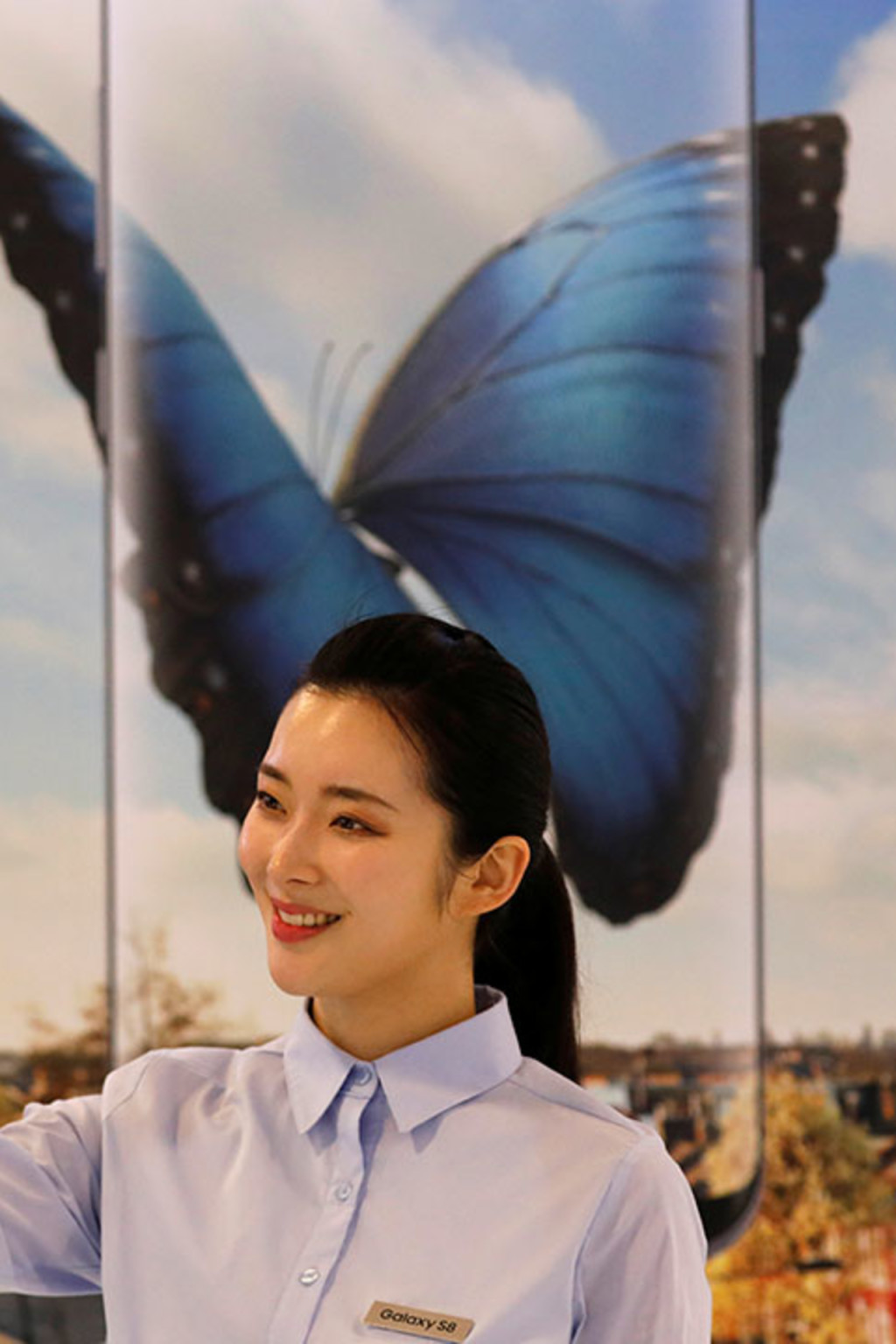 <p>A model poses with a Samsung smartphone. </p>