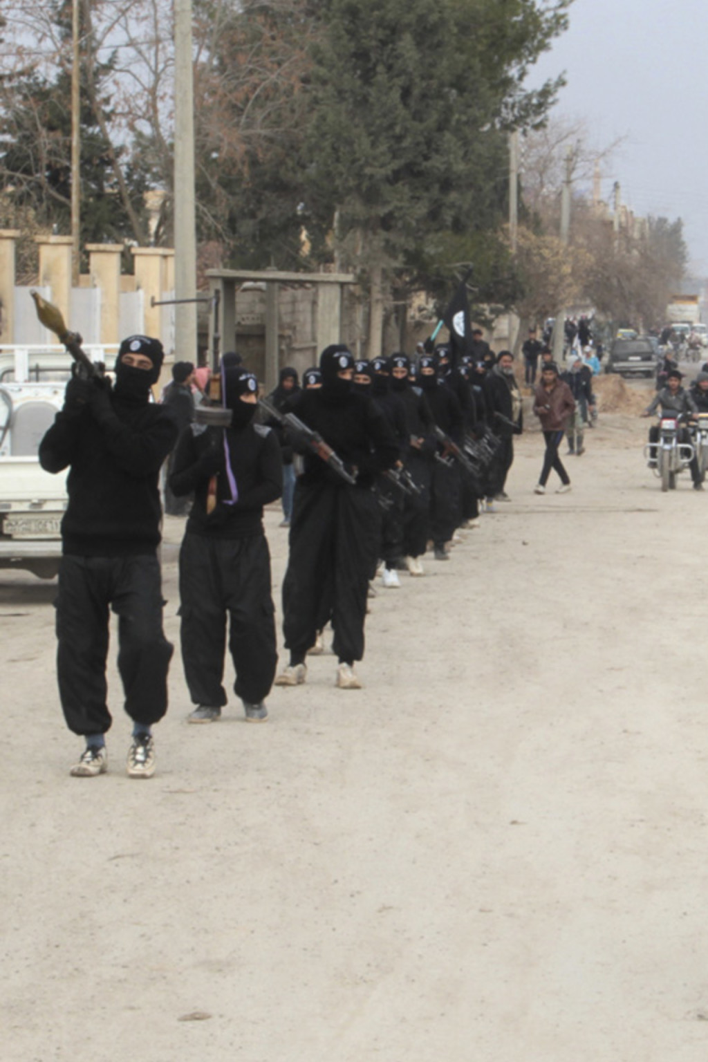 <p>Islamic State militants parade in Tel Abyad, near Syria’s border with Turkey.</p>