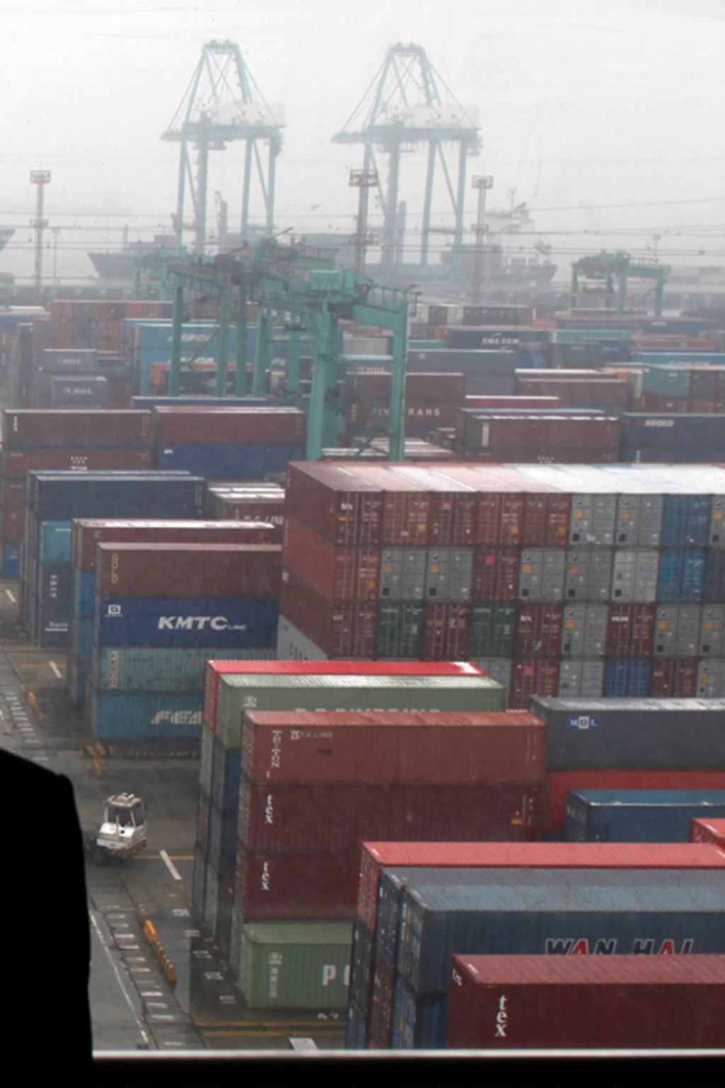 <p>An employee surveys shipping container traffic at the Port of Shanghai. </p>
