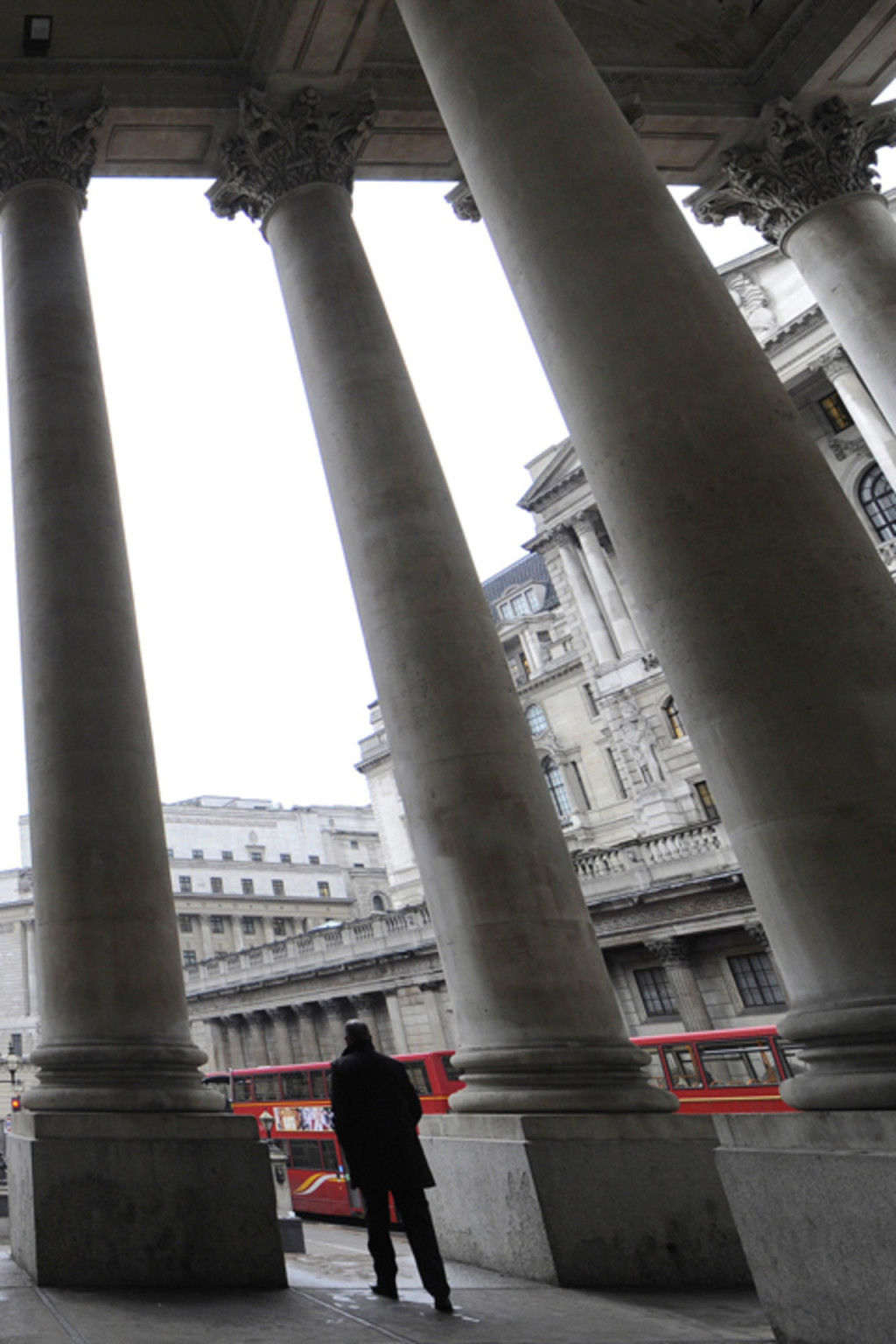 <p>People walk through the Royal Exchange in front of the Bank of England in central London.</p>
