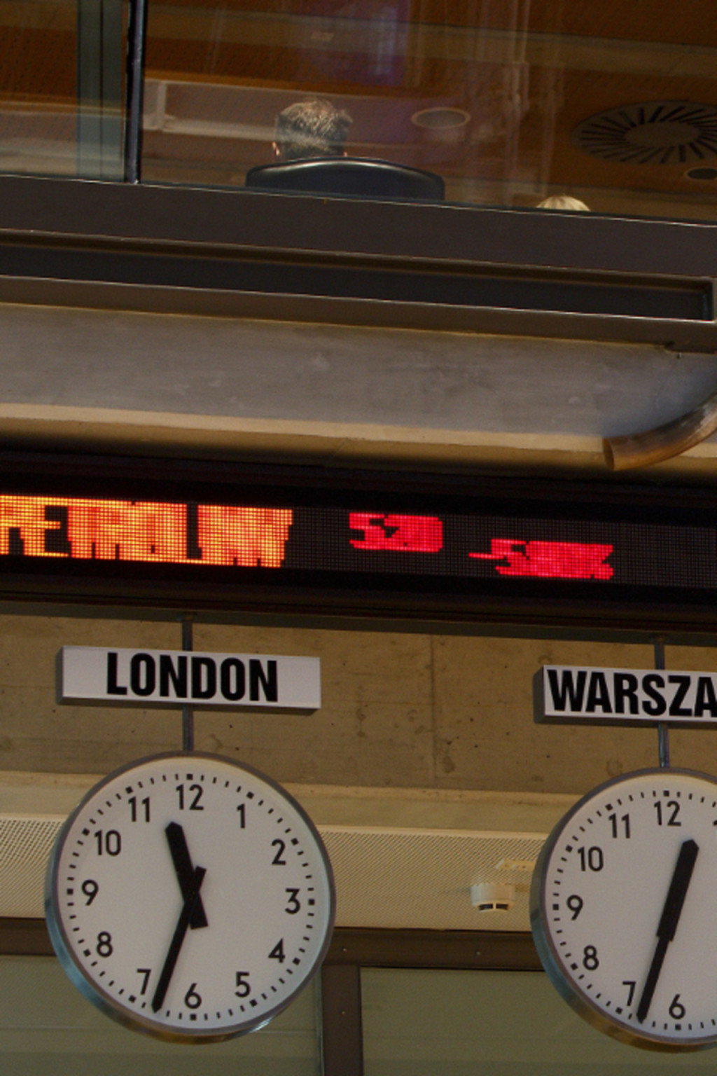 <p>Stock exchange figures are displayed above clocks with time from around the world at Warsaw Stock Exchange.</p>