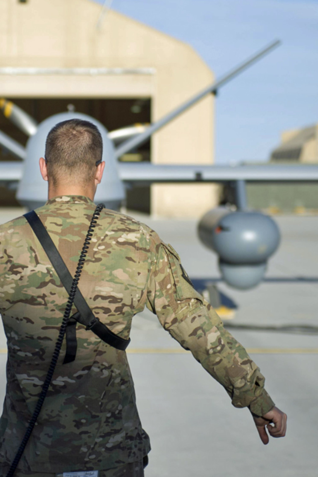 <p>A U.S. airman conducts preflight checks on an MQ-9 Reaper in Afghanistan, 2015.</p>
