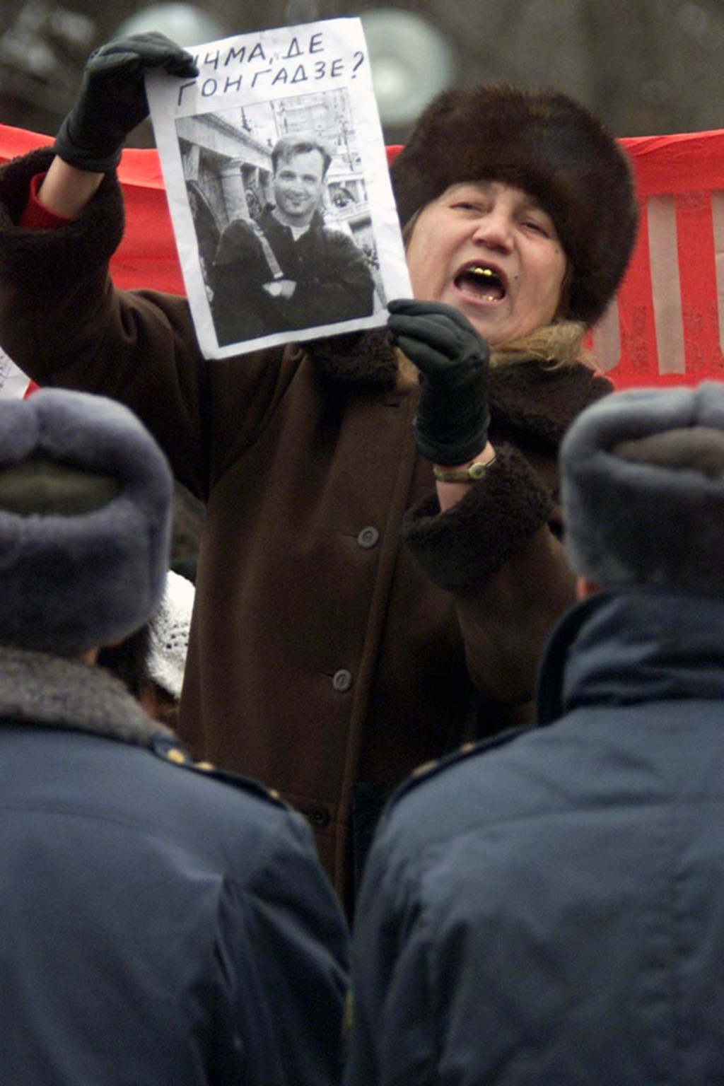 An angry protester waves a poster of missing opposition journalist Heorhiy Gongadze during a rally calling for Kuchma’s resignation in Kyiv, Ukraine, in December 2000. 

