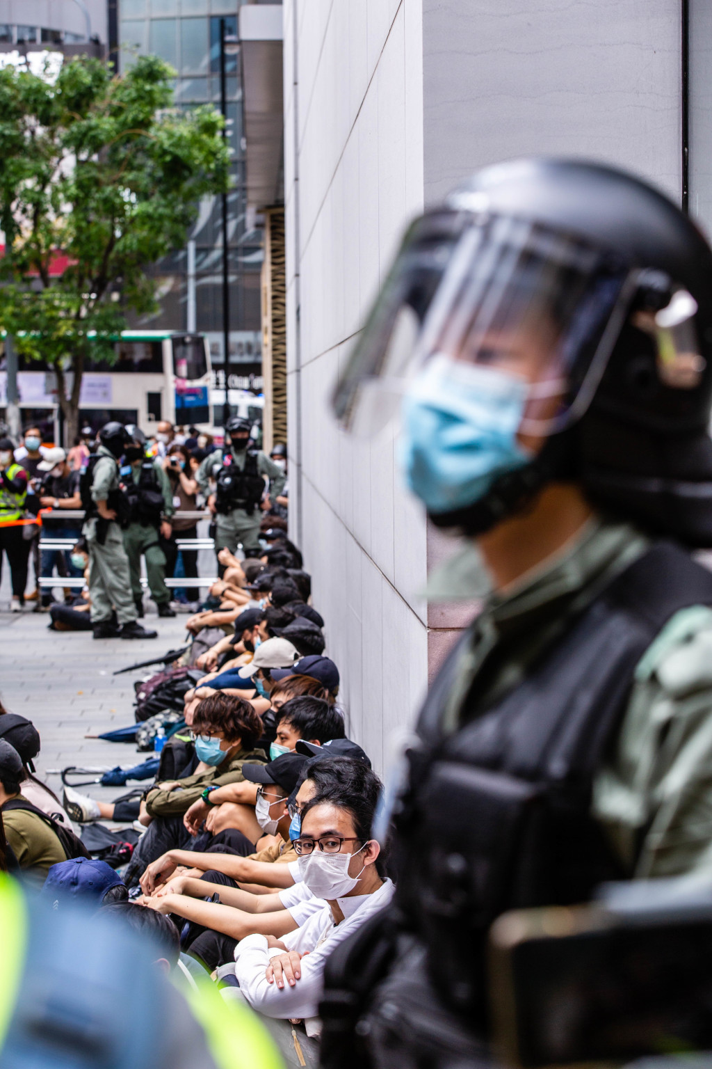 Riot police round up a group of protesters during the