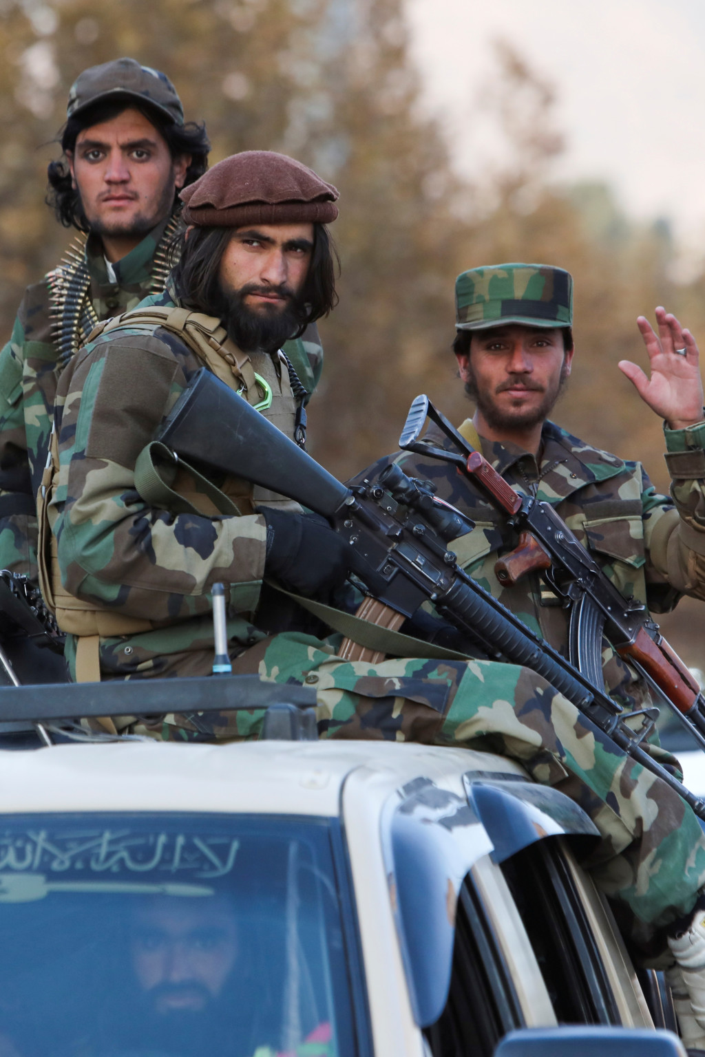 Members of Taliban sit on a military vehicle during Taliban military parade in Kabul