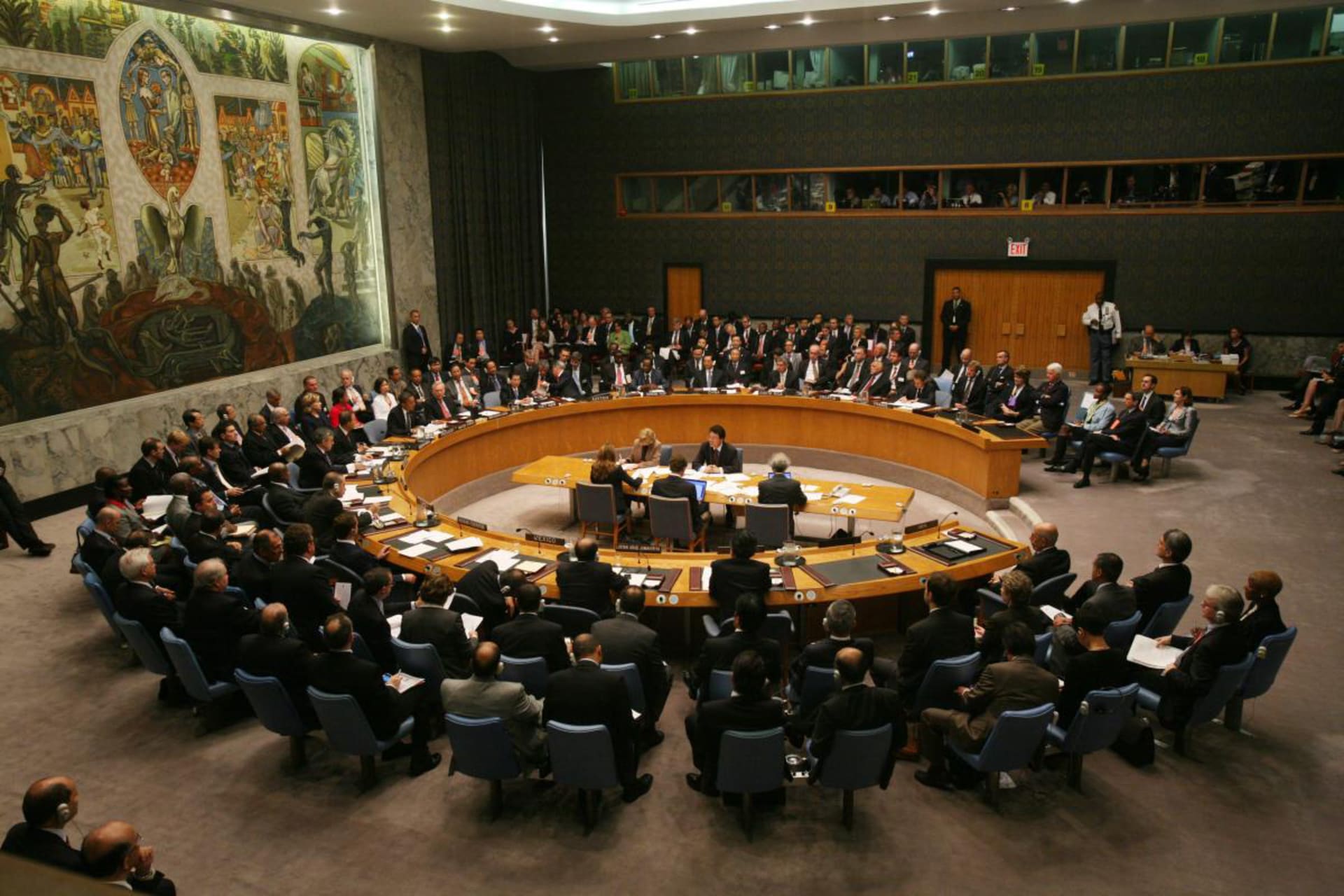 Members sit at the circular table of the UN Security Council.