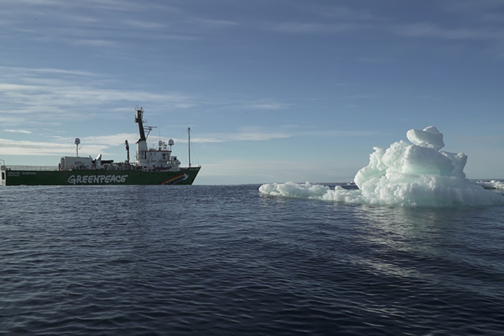 The Greenpeace's Arctic Sunrise ship is seen near floating ice at the Arctic Ocean on September 14, 2020. The ship is on the left, and the iceberg is on the right.