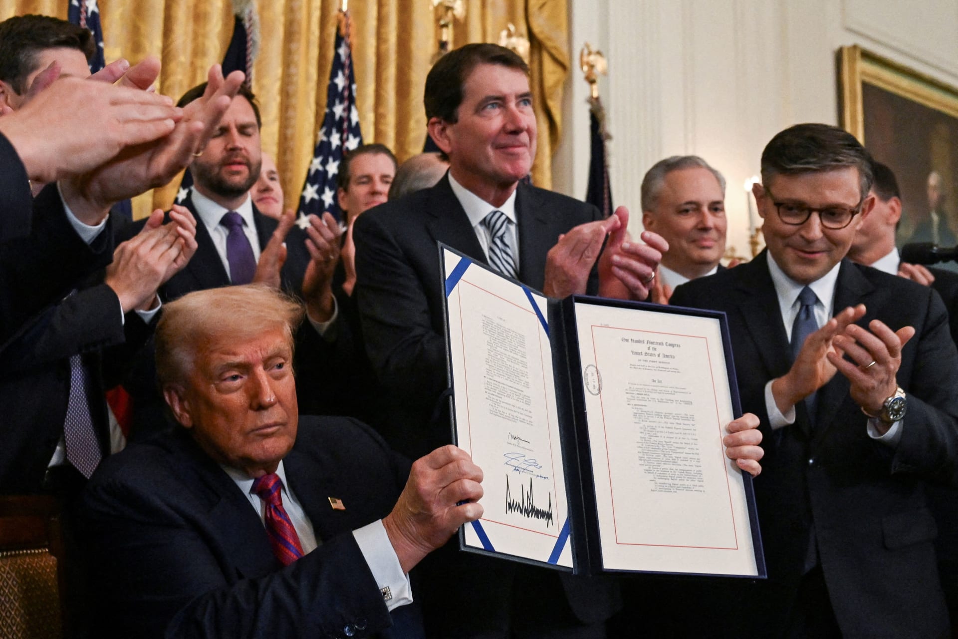 <p>U.S. President Donald Trump holds the signed “Genius Act”, which will develop regulatory framework for stablecoin cryptocurrencies and expand oversight of the industry, at the White House in Washington, D.C., U.S., July 18, 2025.</p>
