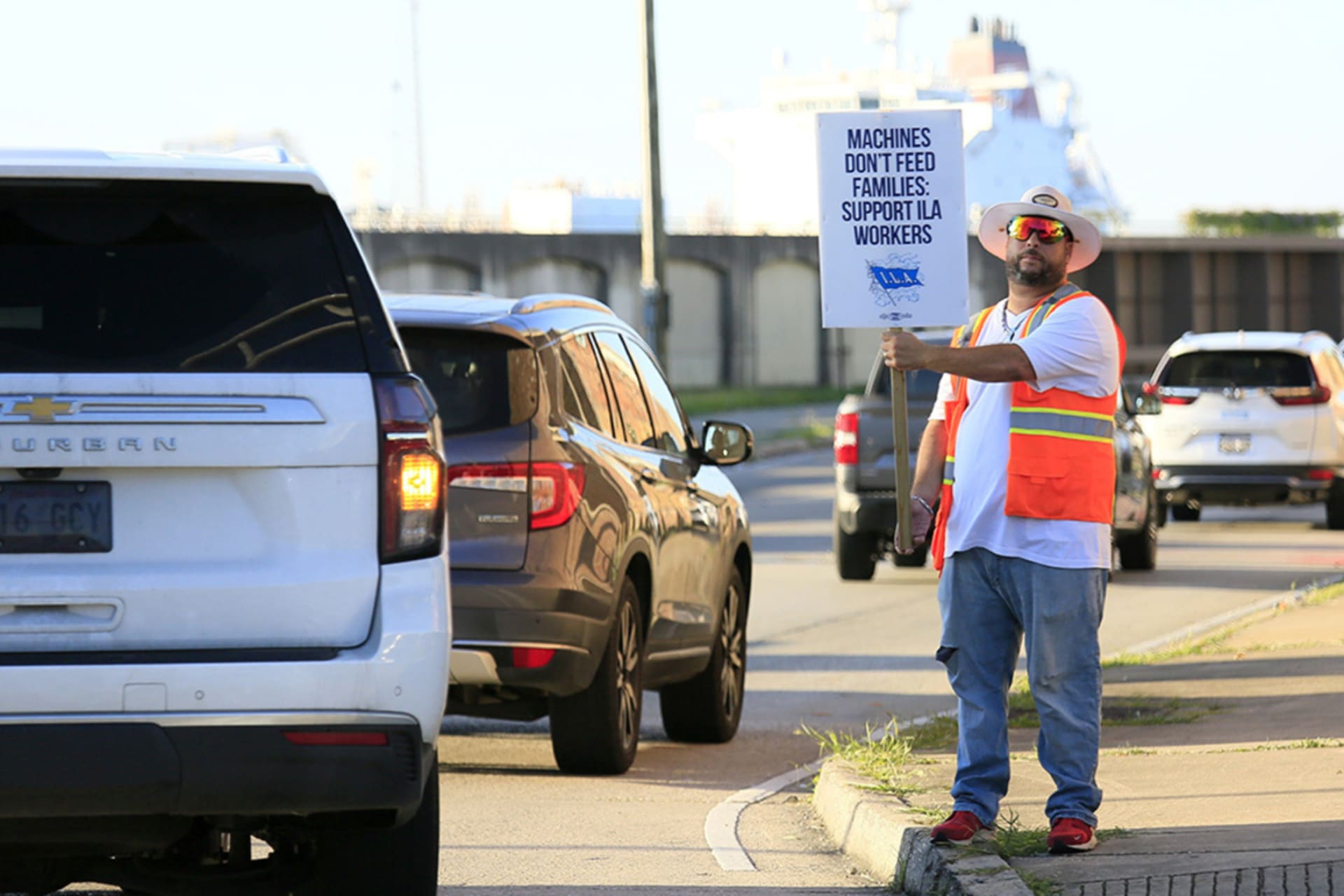 <p>A striking port worker stands at the entrance to the Port of New Orleans, Louisiana, on October 2, 2024. About 45,000 dock workers walked out at 36 U.S. ports amid fears of job loss in an AI-driven future.</p>
