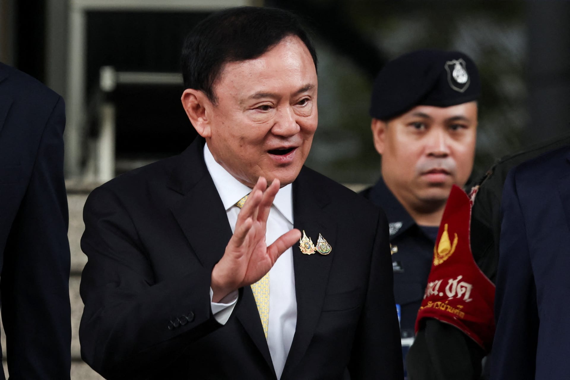 <p>Former Thai prime minister Thaksin Shinawatra waves to supporters as he leaves court after being cleared of charges in a lese majeste case, also known as a royal insult case, under Section 112 of Thailand’s Criminal Code.</p>
