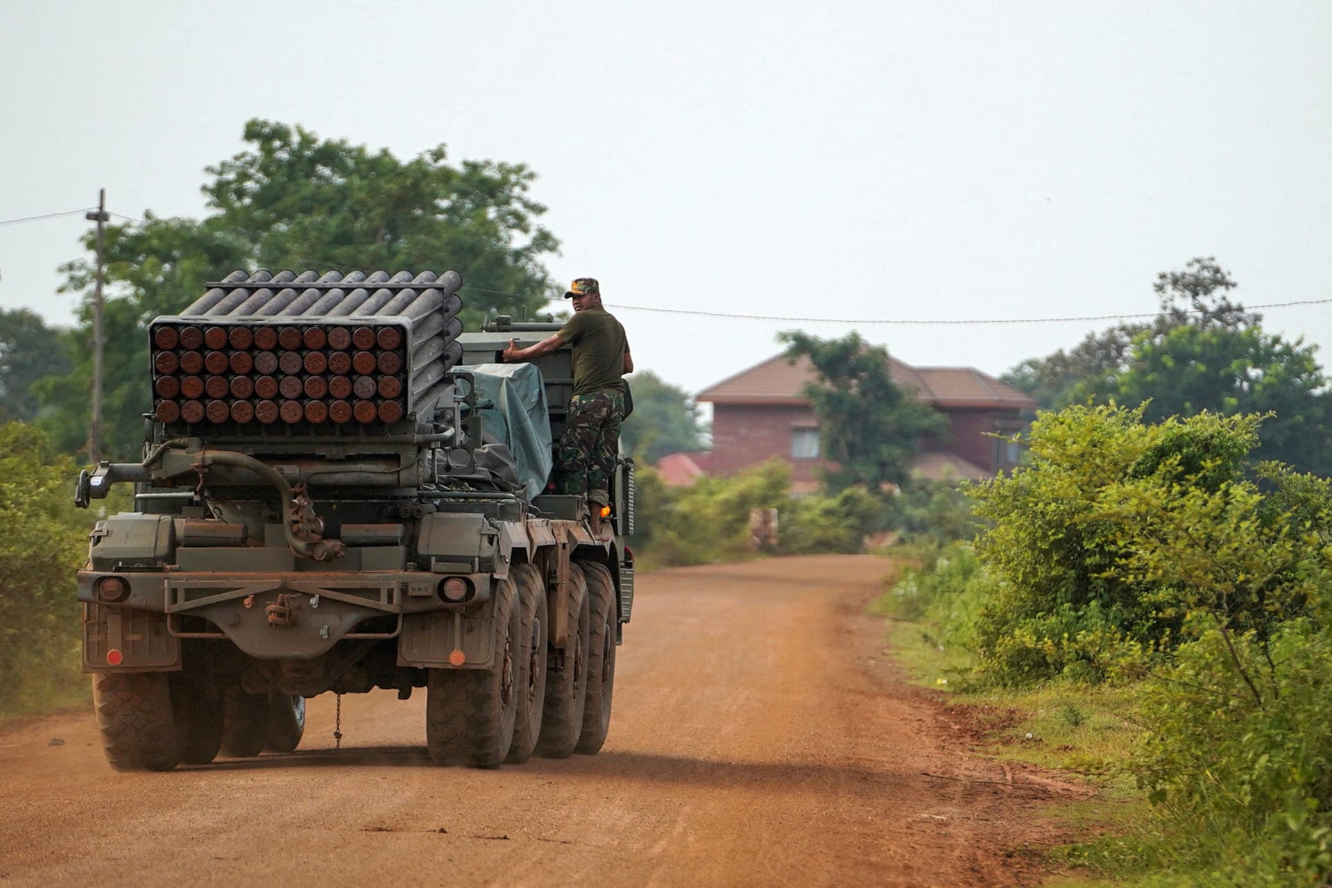 <p>A Cambodian military personnel stands on a BM-21 Grad multiple rocket launcher in Oddar Meanchey province, Cambodia, on July 25, 2025.</p>
