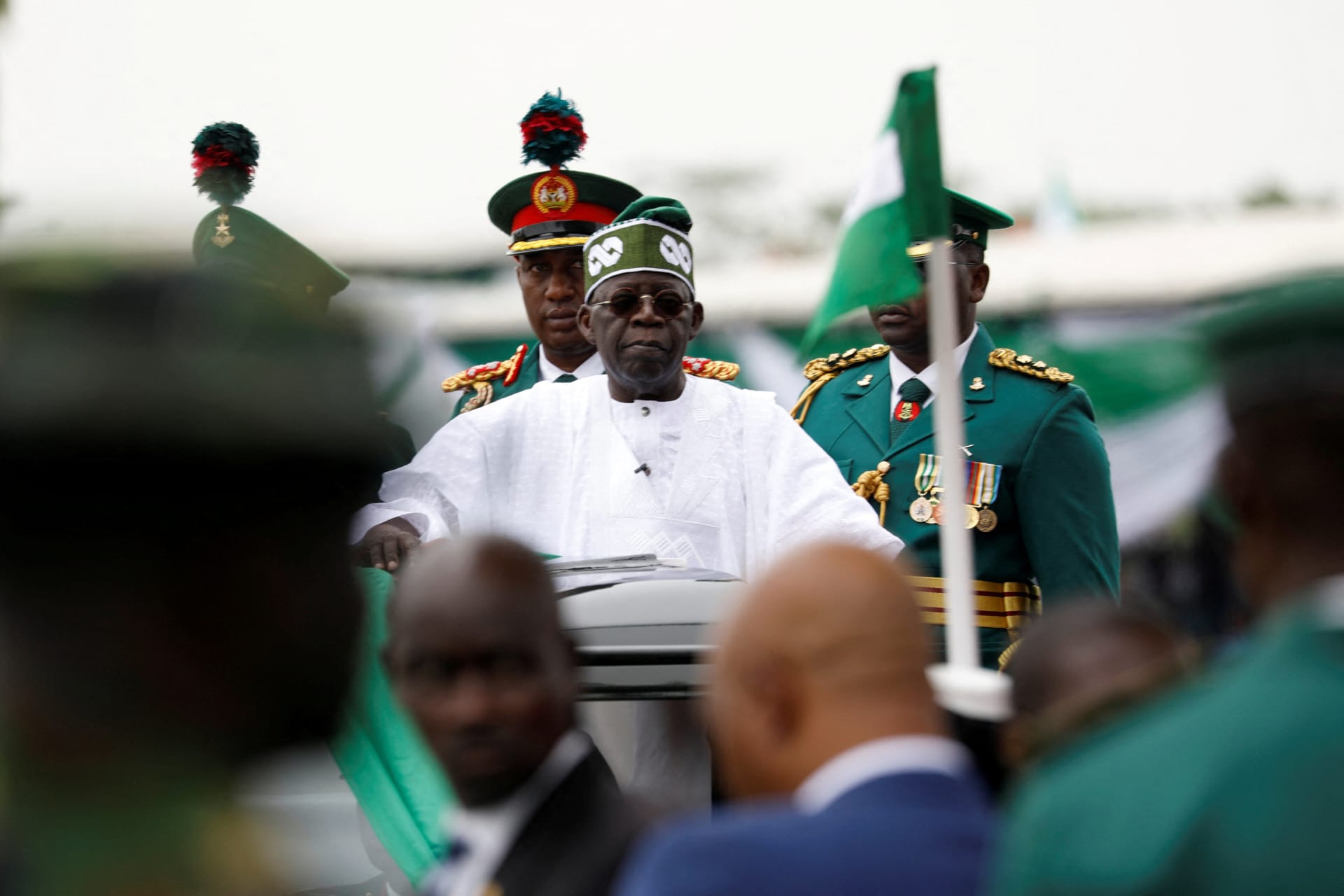 <p>Nigeria’s President Bola Tinubu looks on, as he takes the traditional ride on top of a ceremonial vehicle, after his swearing-in ceremony in Abuja, Nigeria on May 29, 2023.</p>
