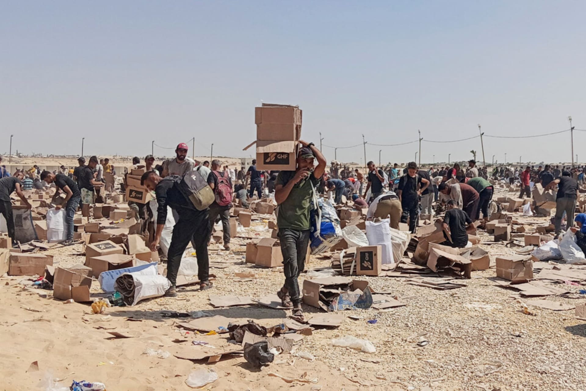 <p>Palestinians collect what remains of relief supplies from the distribution center of the U.S.-backed Gaza Humanitarian Foundation, in Rafah, in the southern Gaza Strip, June 5, 2025.</p>